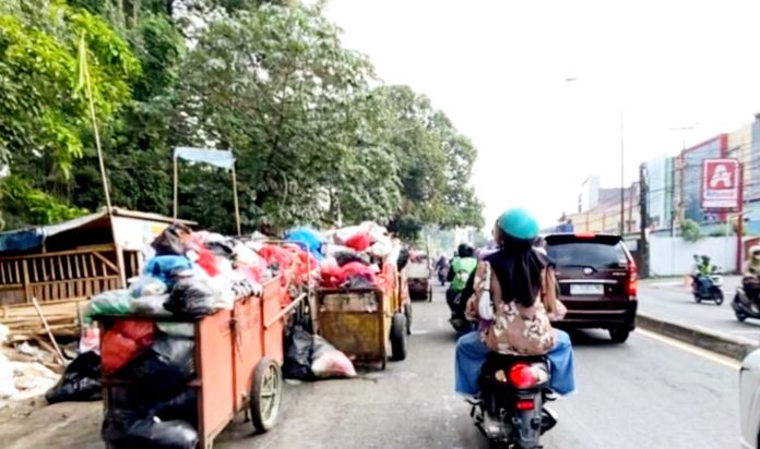 Pemandangan sampah yang menggunung di ialan Raya Bogor - Jakarta, tepatnya di wilayah Cimanggis kota Depok, Jawa Barat.